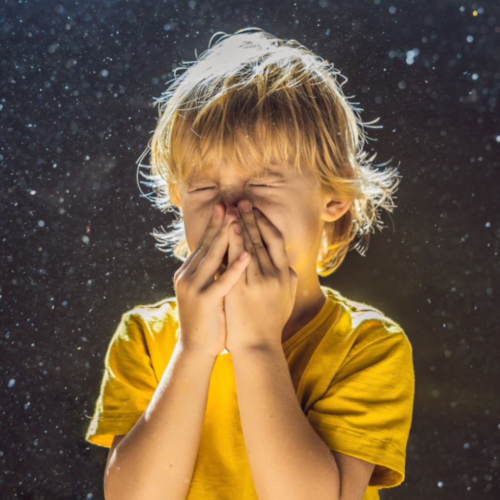 Child sneezing inside from the dust and poor indoor air quality
